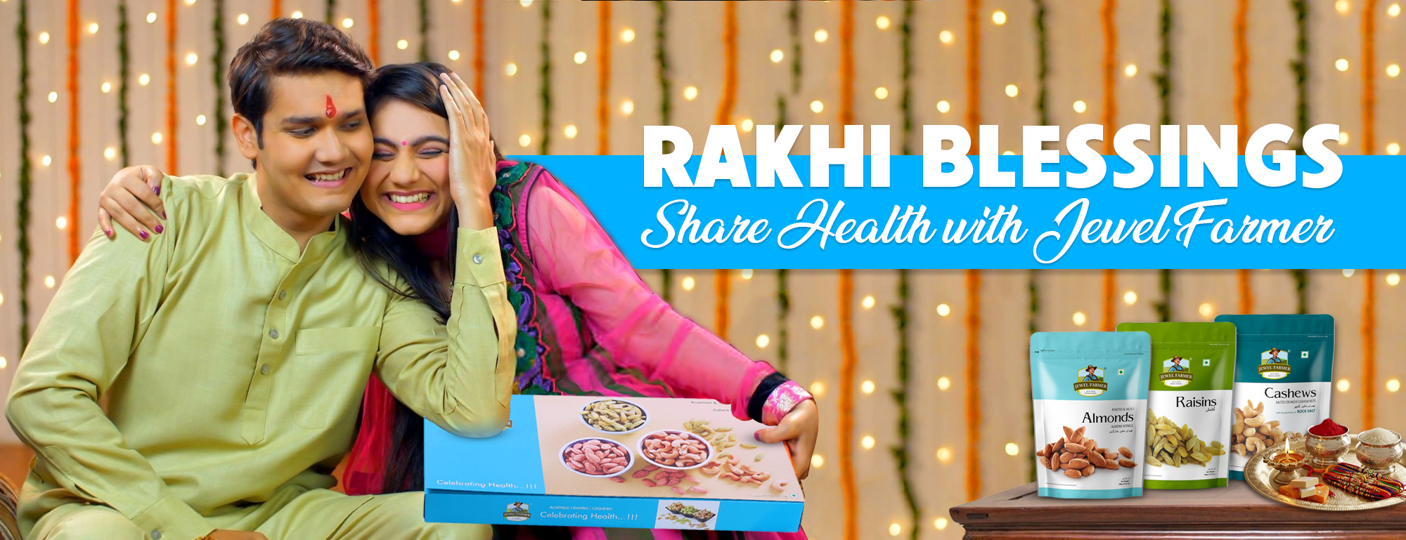 Two people sitting together with a box of dryfruits Gifts, surrounded by more  dryfruits gift box on a table, with 'Rakhi Blessings' text overlay.